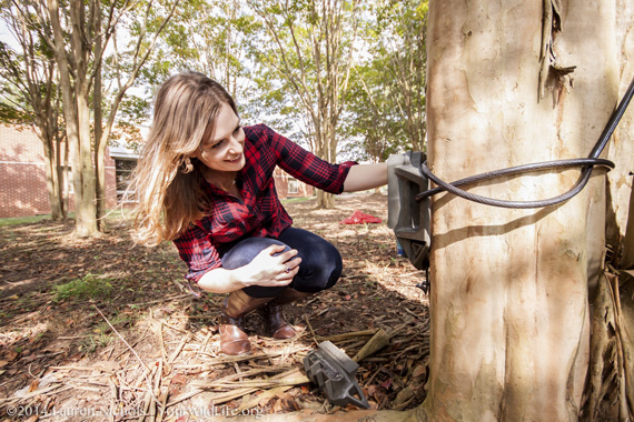 Stephanie Schuttler setting up a camera trap.
