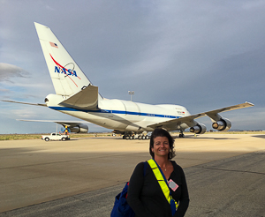 Dr. Smith on the tarmac at the Armstrong Flight Research Center in Palmdale, CA, getting ready to board the SOFIA aircraft to observe massive forming stars.