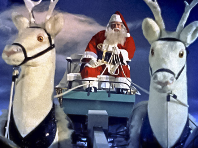 Santa Claus (1959) still image showing Santa, sleigh, and two white reindeer.