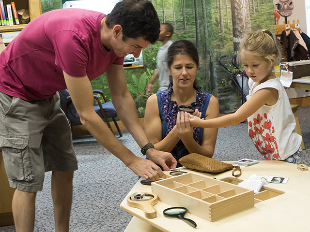 A family explores the Discovery Room.