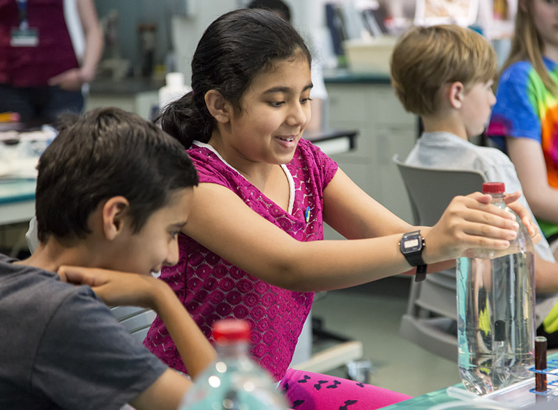 A girl experiments with a Cartesian diver she has just made at Triangle SciTech Expo 2016. Photo: Karen Swain/NCMNS.