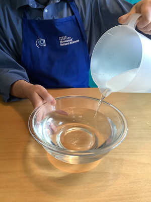 Pouring water into bowl.