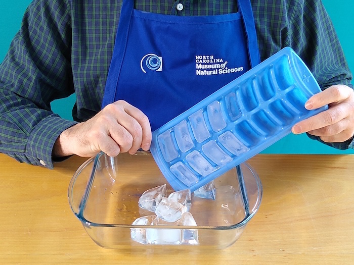 Cubes are dropped into a dish pan
