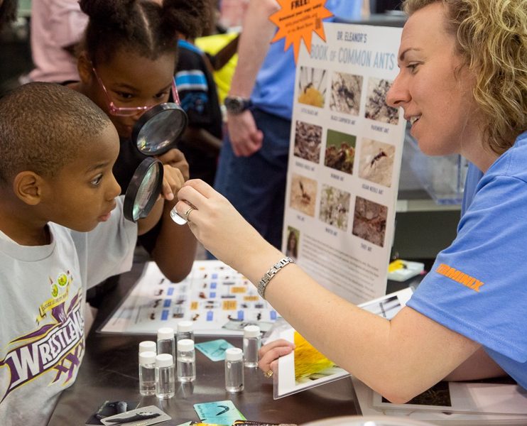Naturalist teaching children about bugs