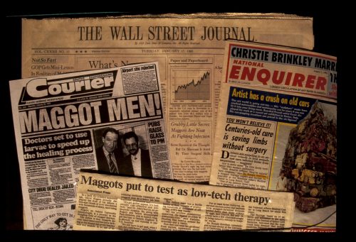 Newspapers with headlines about maggot therapy in medicine