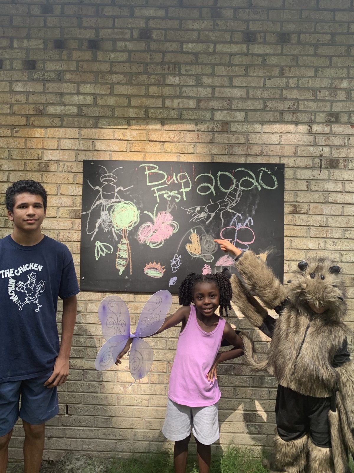 Three kids and a bugfest chalkboard-one is a hairy spider costume