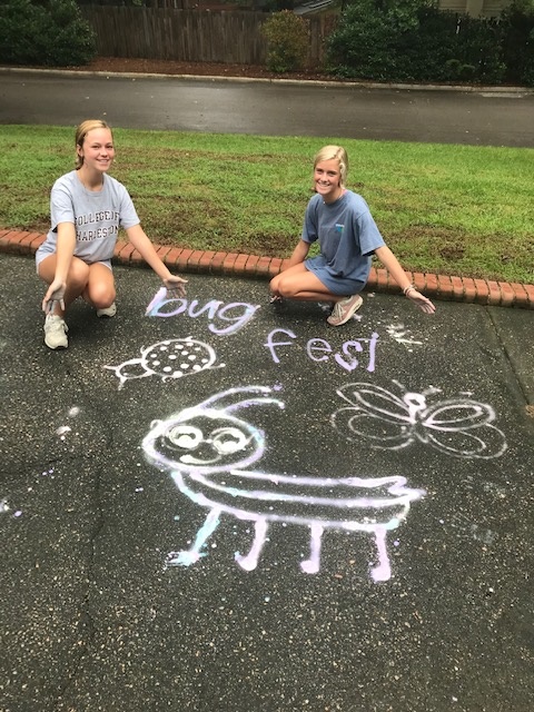 A cutechalk bug and two young girls