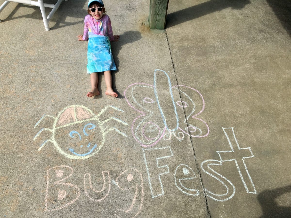 A little girl in sunglasses by bugfest in chalk