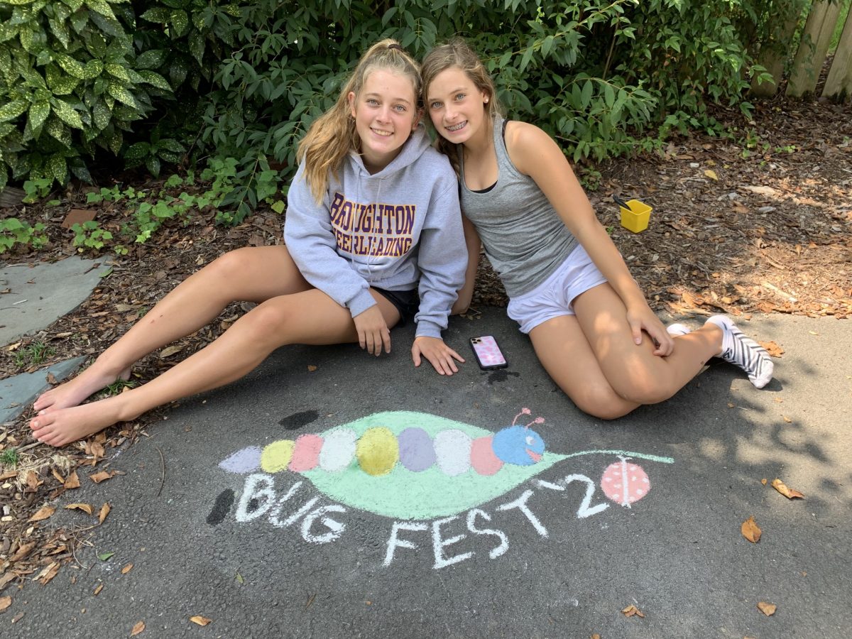 Two young girls and a chalk bugfest with a caterpillar