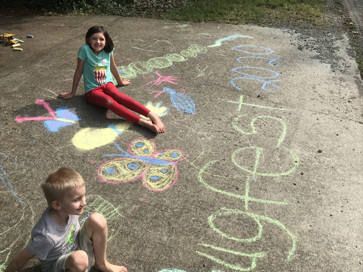 two kids with chalk art