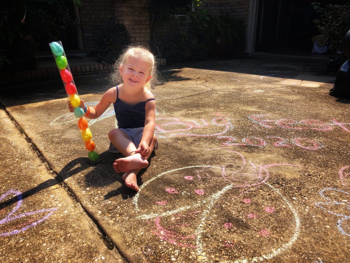 A little girl with sidewalk chalk