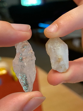 Hand holding two crystals.