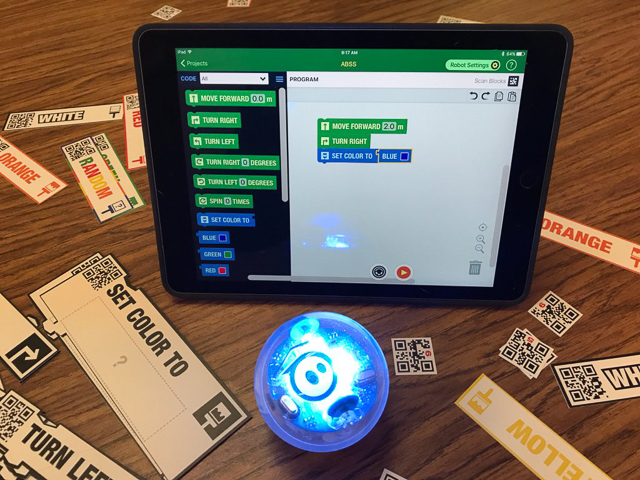 CodeSnaps running on an iPad with a Sphero robot in front.