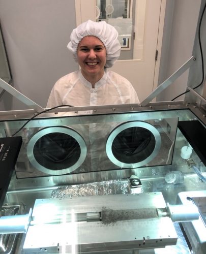 A woman in lab gear by an instrument sampling moon specimens
