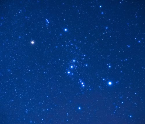 A blue sky with Orion's stars shining brightly.