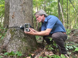 Roland Kays accessing a camera trap