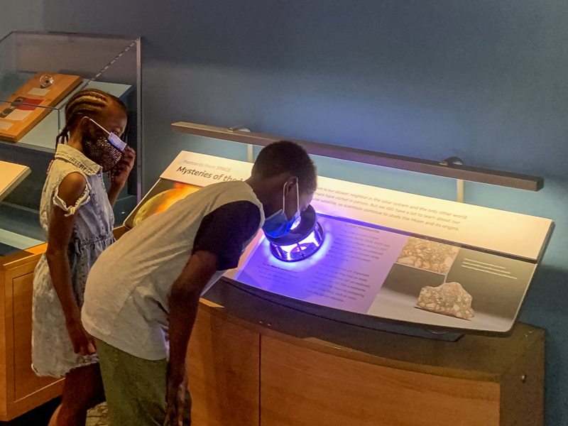 Kids investigating Lunar Meteorite Exhibit.
