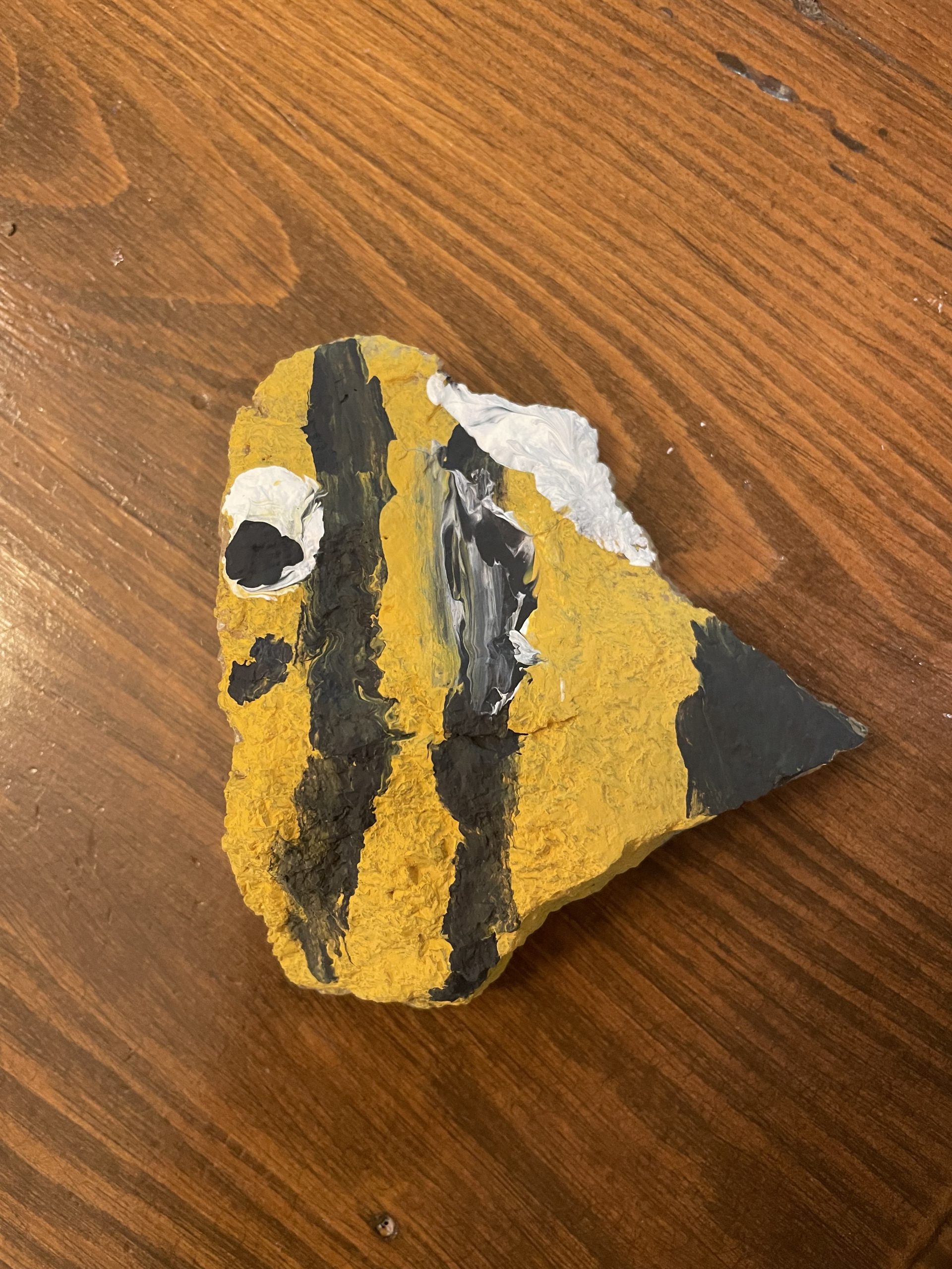 A rock painted like a bee