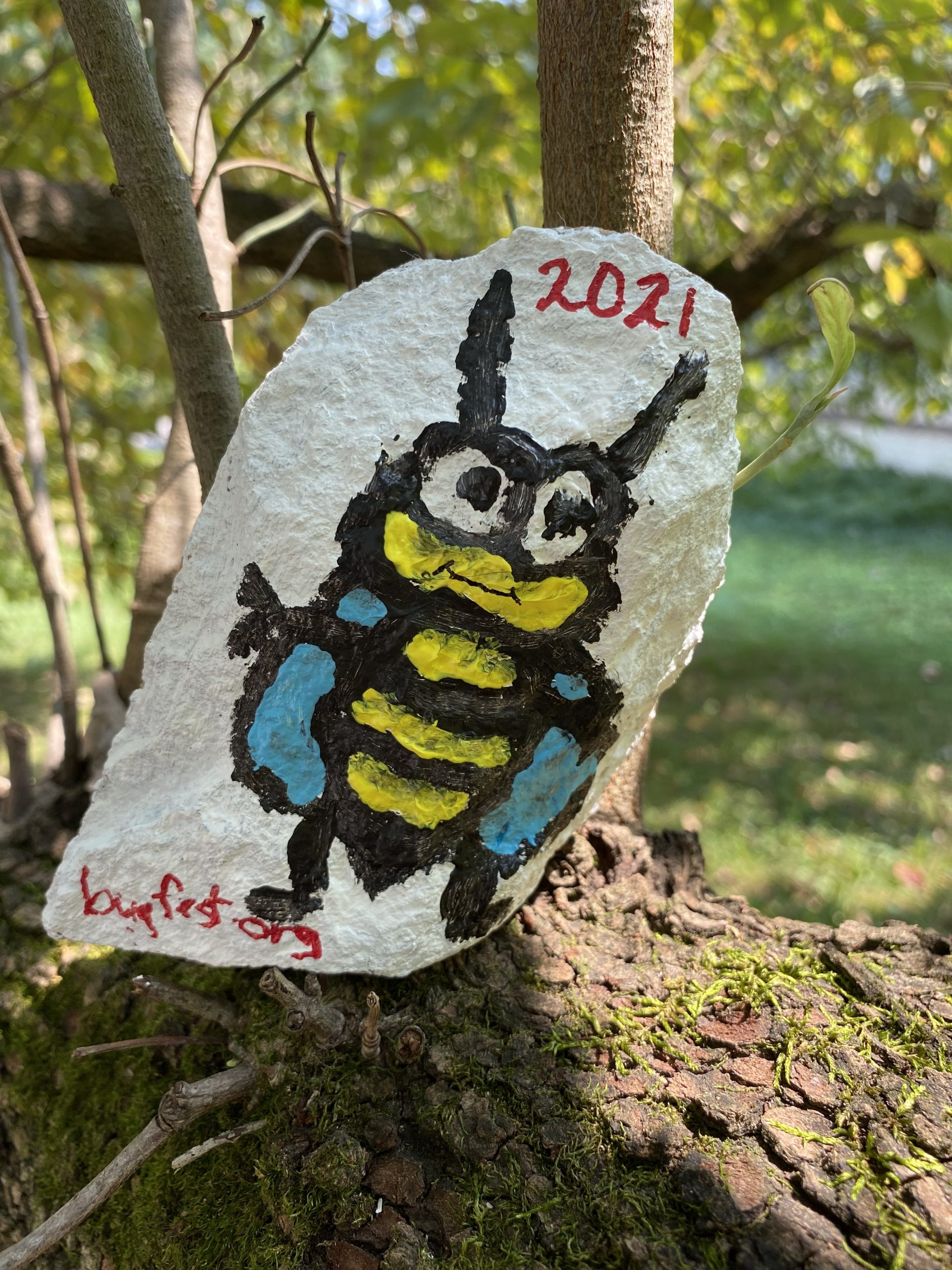 a bee painted on a rock