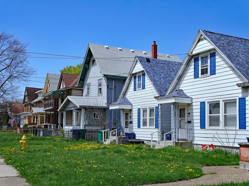 Row of lower-income houses with little tree cover.