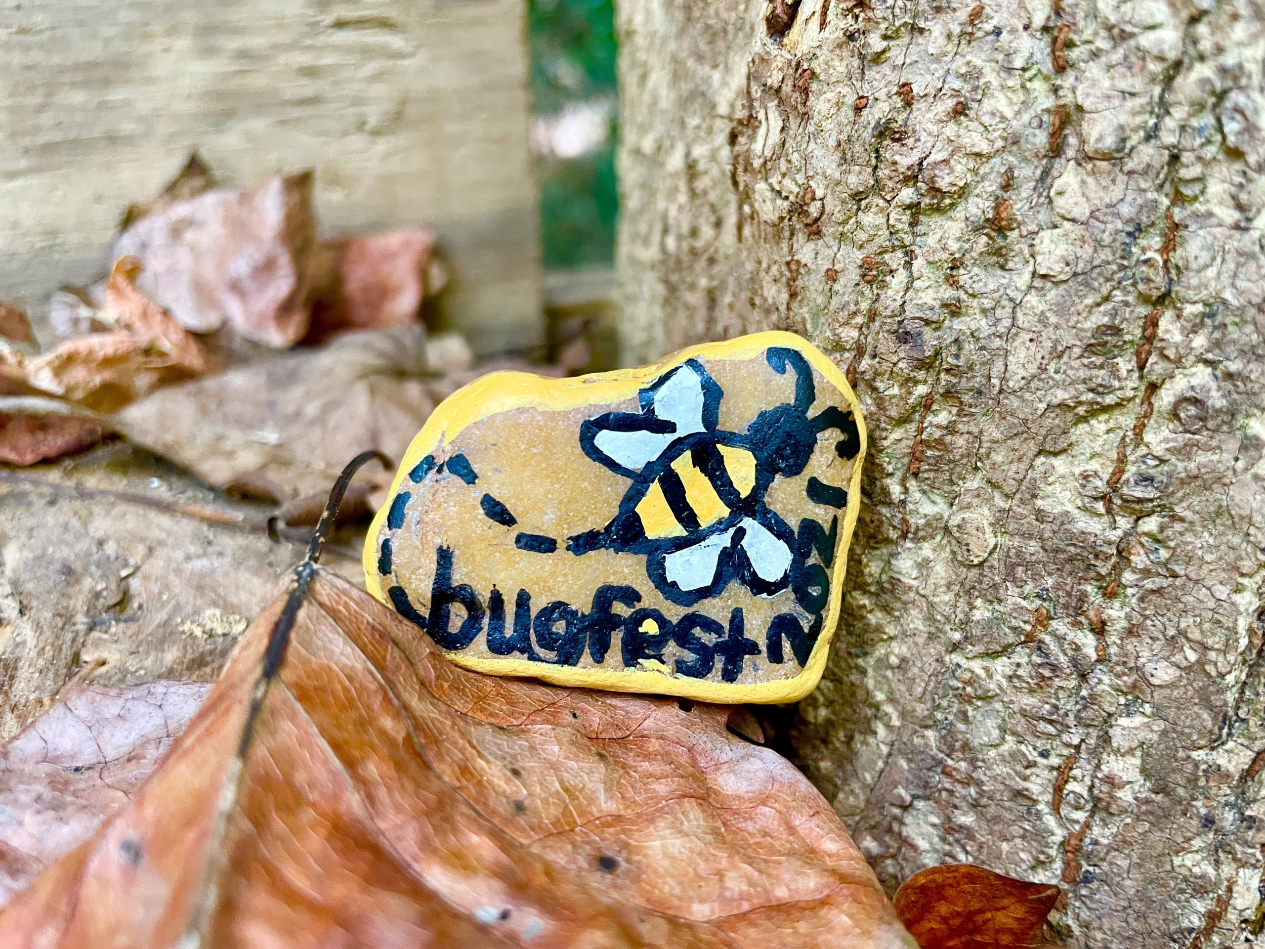 a bee painted on a rock