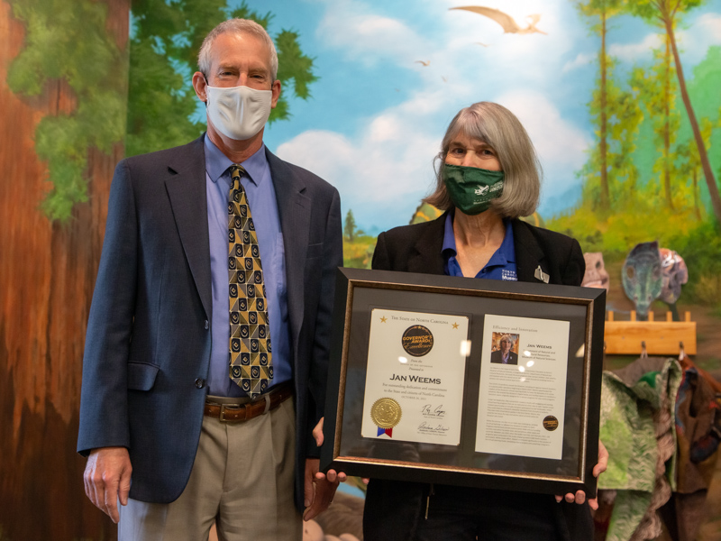 NCDNCR Secretary Reid Wilson presents Museum educator Jan Weems with the Governor's Award for Excellence