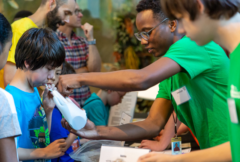 Volunteer and a young guest at SciTech Expo 2018. Photo: Karen Swain/NCMNS.