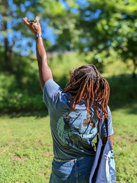 Program leader Deja Perkins playing calls and songs of the Indigo Bunting (Passerina cyanea) to draw out one sighted along the walk. Photo: Michael Lewis/NCMNS.
