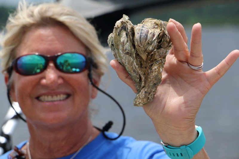 Pat Donovan holding an oyster.