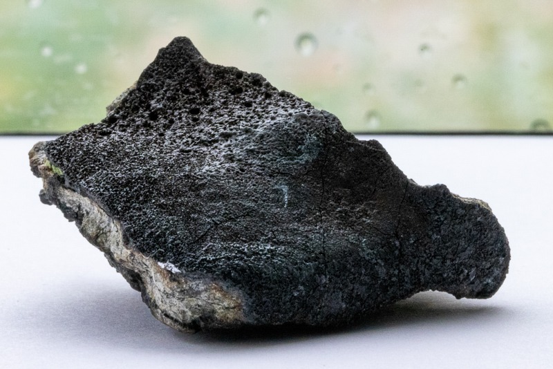 Chelyabinsk meteorite, NCMNS permanent collection. This meteorite has a well-preserved fusion crust and cracked interior. This meteorite is currently not on display, but a similar one can be found in our meteorite gallery. 