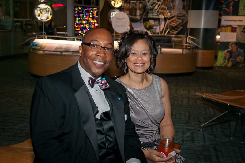 Guests at a black-tie Museum event smile and look towards the camera.