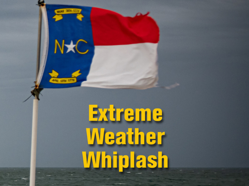 The NC flag flies in strong winds on a long pier with large waves and dark clouds