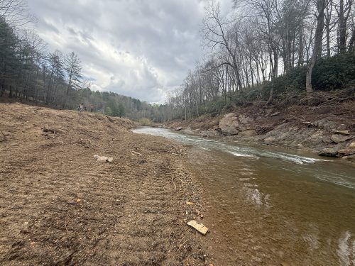 Photo of a river bank washed clear of vegetation by hurricane helene