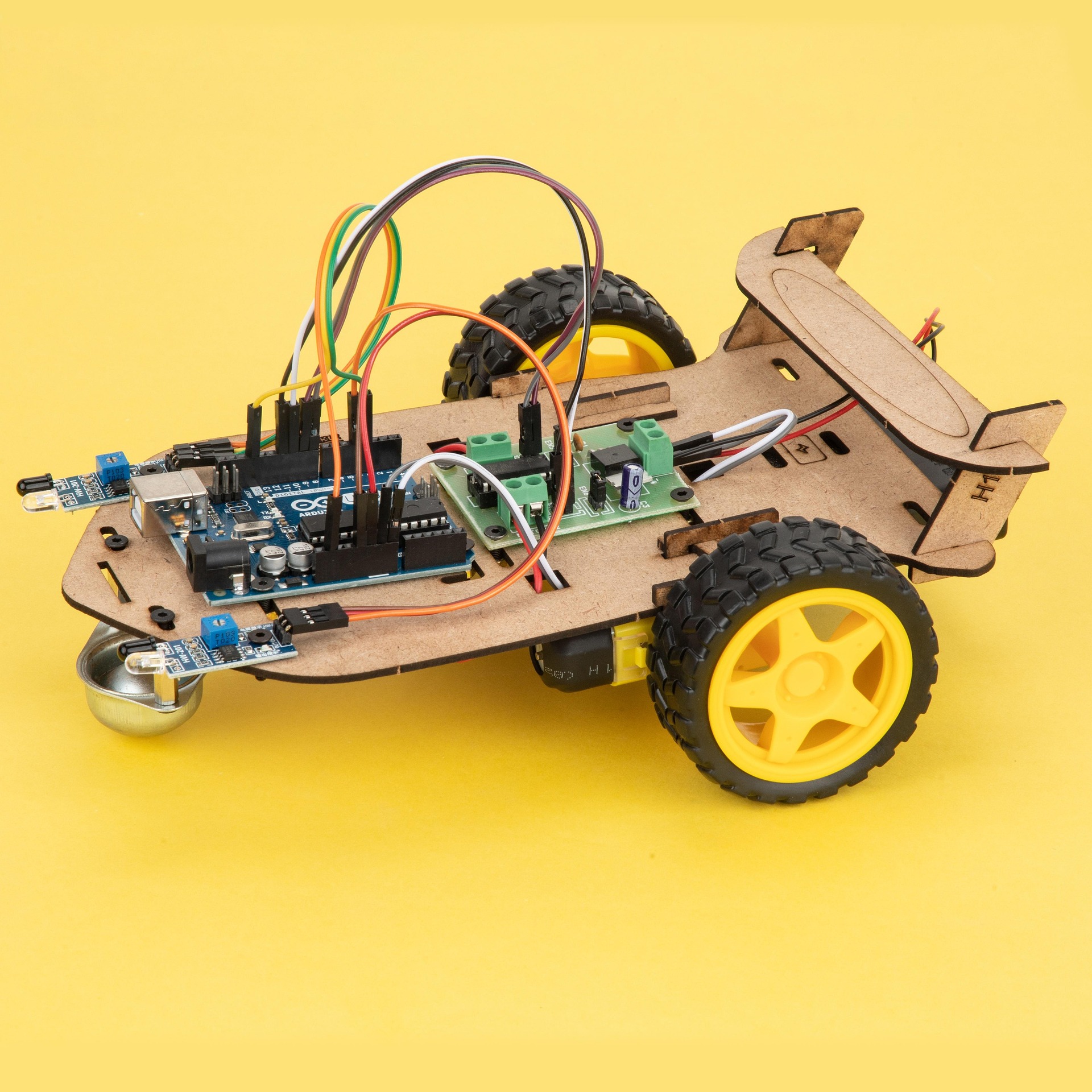 close up image of a custom robot featuring wheels, wires, circuit boards, and connectors