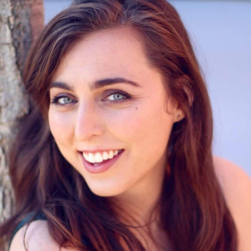 Head-and-shoulders portrait of Brett Williams smiling and looking to the camera against a light colored background