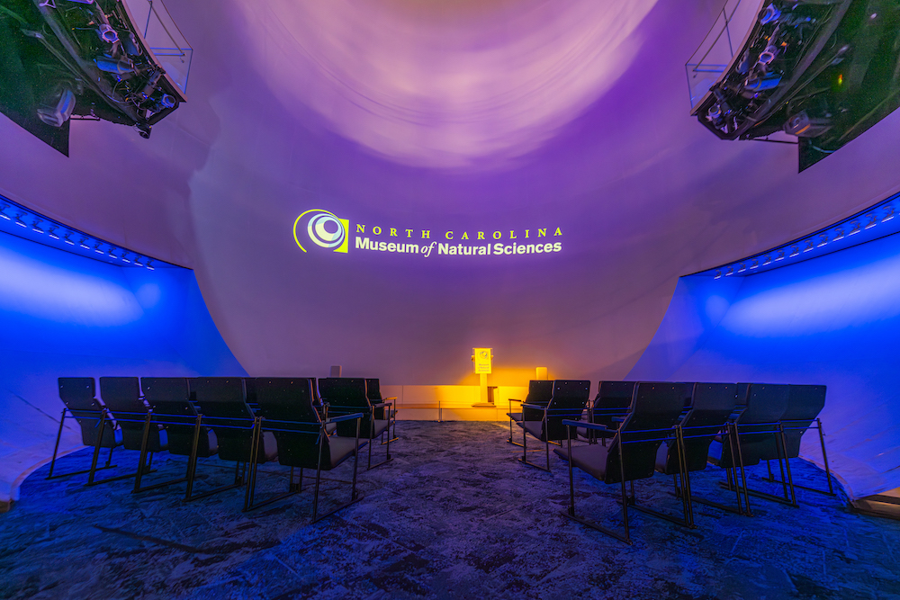 An empty Daily Planet Theater with mood lighting.