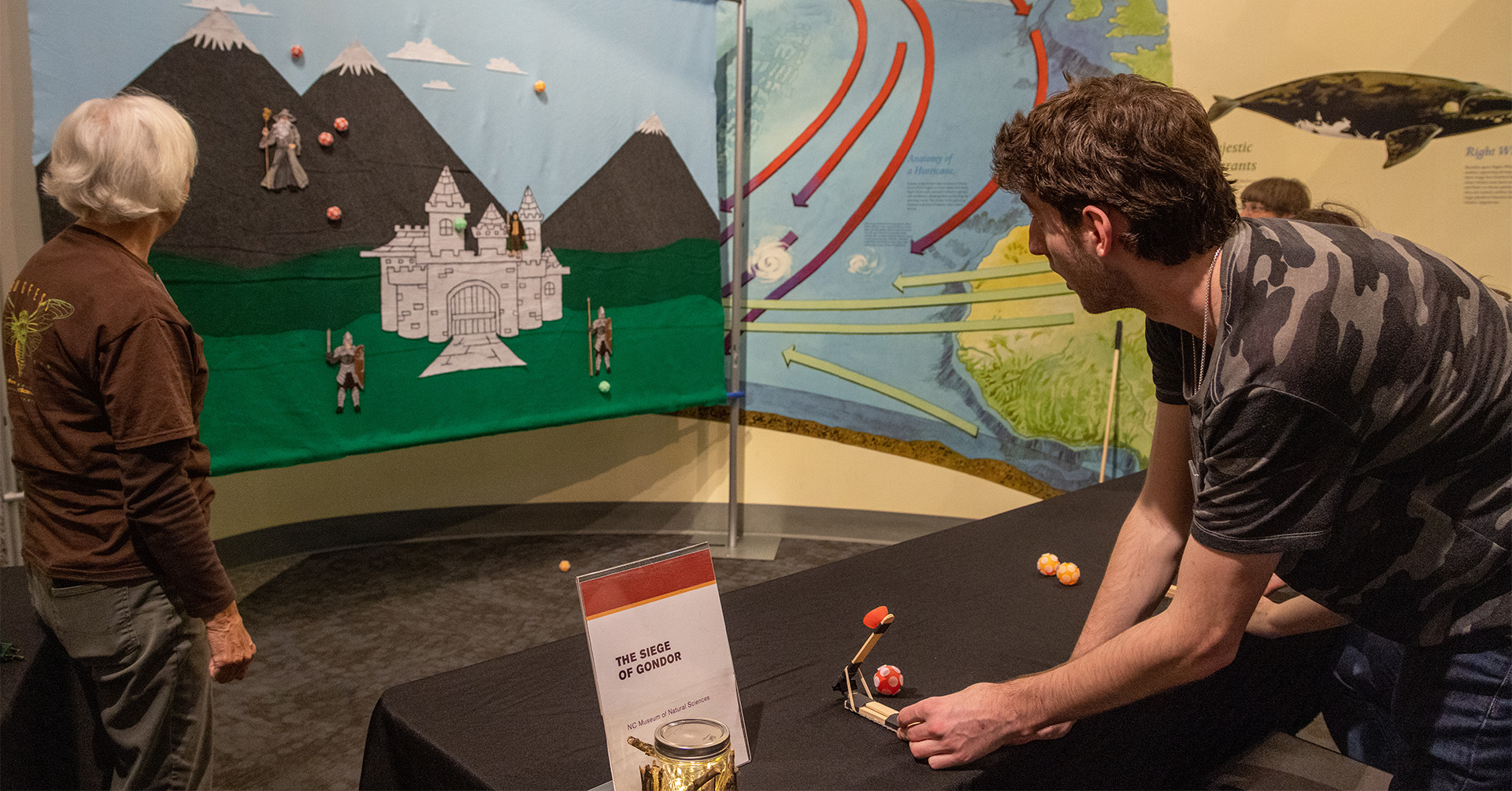 a man uses a mini catapult