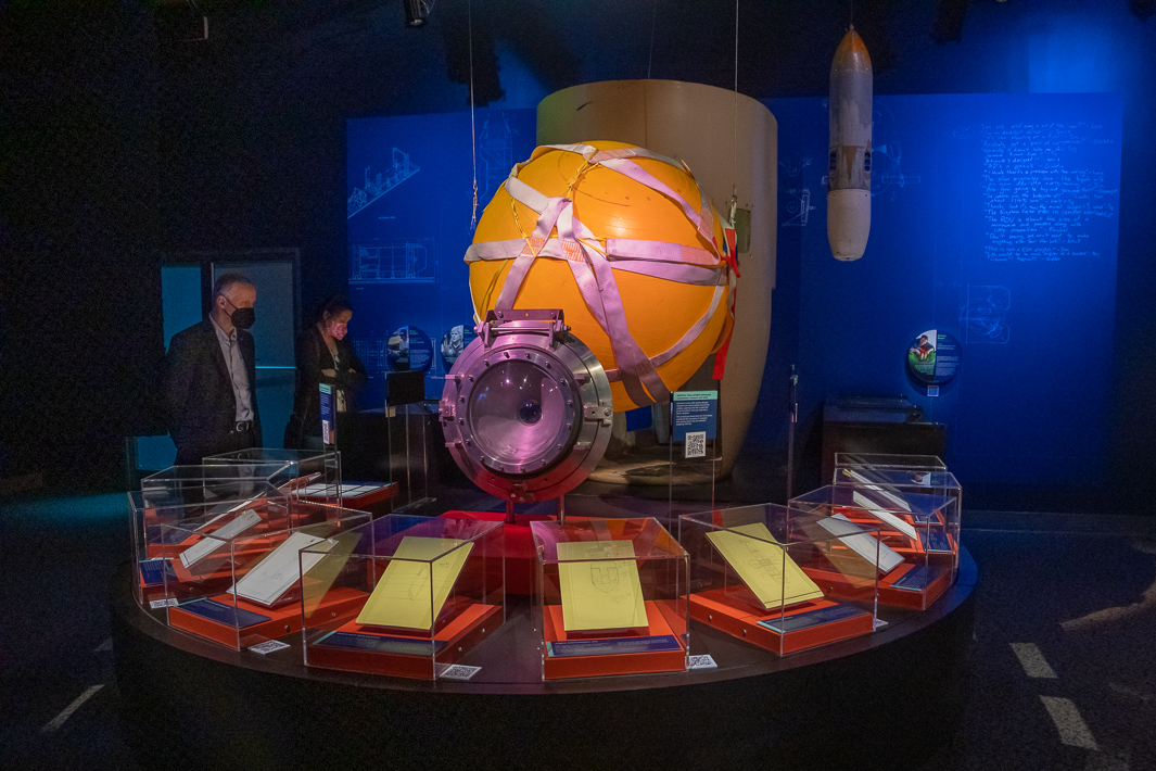 Guests viewing a prototype pilot sphere and notes and schematics by James Cameron.