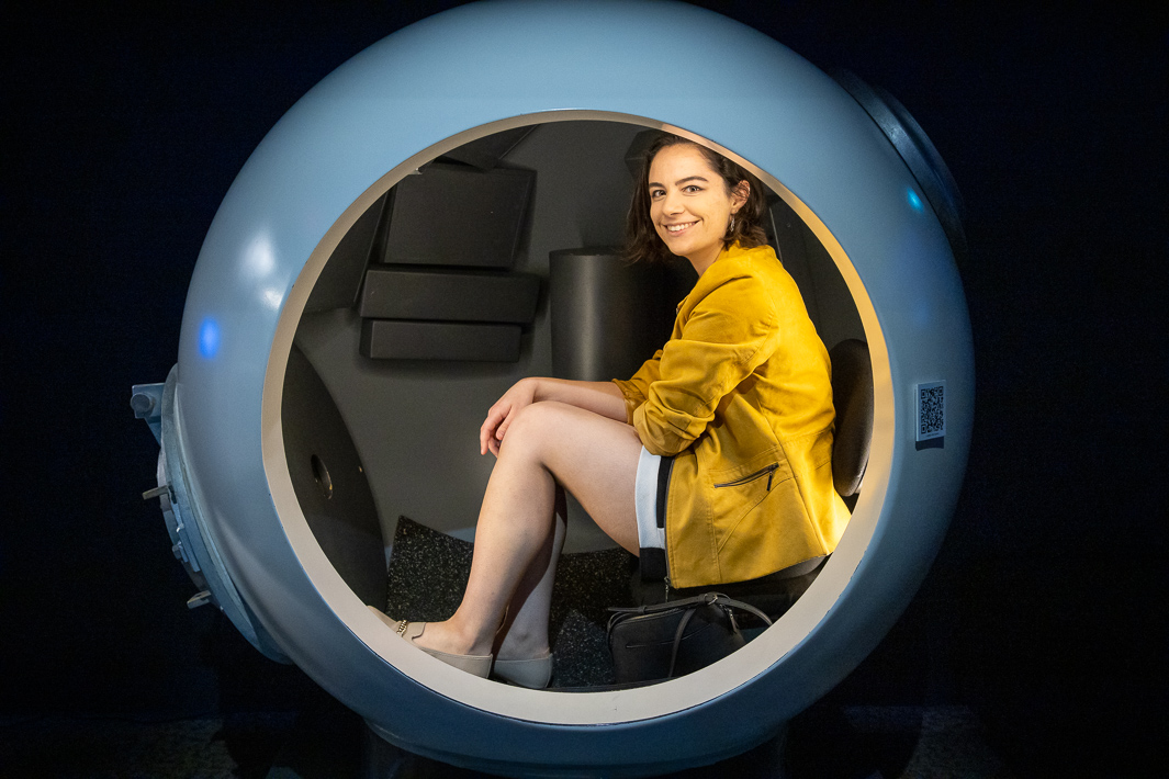 Guest sitting in a replica of the pilot sphere James Cameron dove to the bottom of the Mariana Trench in.