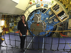 Dr. Smith inside SOFIA, showing the part of the telescope that extends into the main cabin.